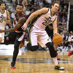 Utah Jazz shooting guard Gordon Hayward (20) is fouled by Portland Trail Blazers point guard Mo Williams (25) as the Utah Jazz is defeated by the Portland Trail Blazers 105-94 in NBA basketball Monday, Dec. 9, 2013, in Salt Lake City.