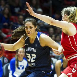 Brigham Young forward Kalani Purcell (32) drives against Utah guard Paige Crozon (14) during an NCAA women's college basketball game against Brigham Young in Salt Lake City on Saturday, Dec. 10, 2016. Utah defeated rival Brigham Young 77-60.