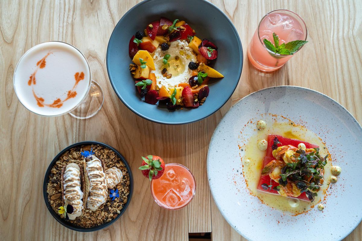 A bird’s eye view of an array of colorful dishes and drinks at Sawyer. 