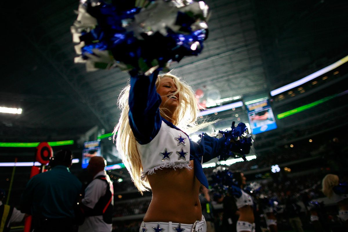 The Dallas Cowboys cheerleaders perform during the Thanksgiving Day game at Cowboys Stadium.