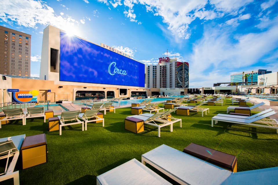An outdoor pool with a very large screen