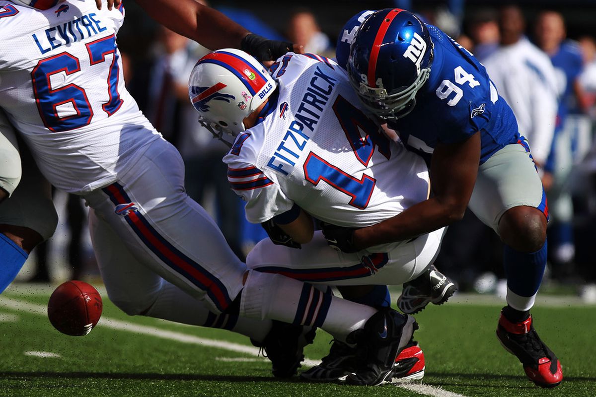 Mathias Kiwanuka of the New York Giants sacks Ryan Fitzpatrick of the Buffalo Bills forcing a fumble at MetLife Stadium on October 16, 2011 in East Rutherford, New Jersey.  (Photo by Nick Laham/Getty Images)