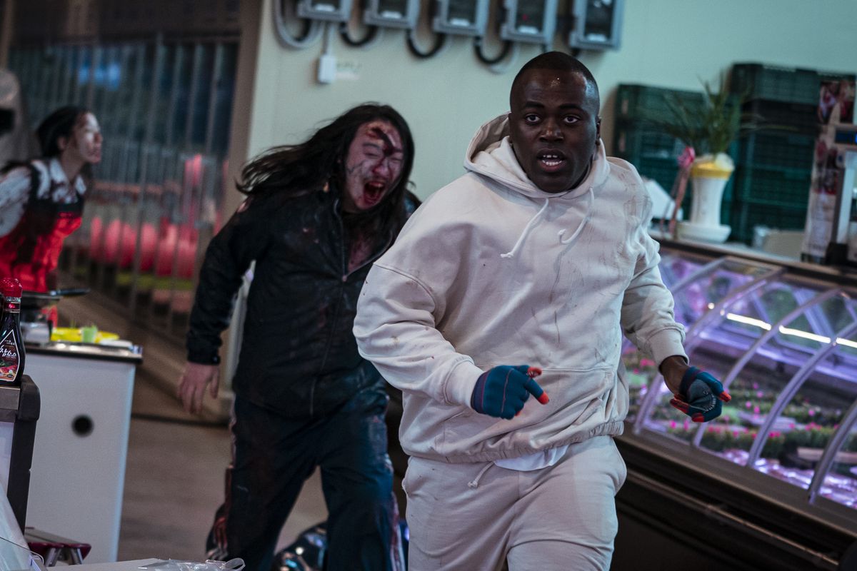 A person running from a zombie in a still from Zombieverse
