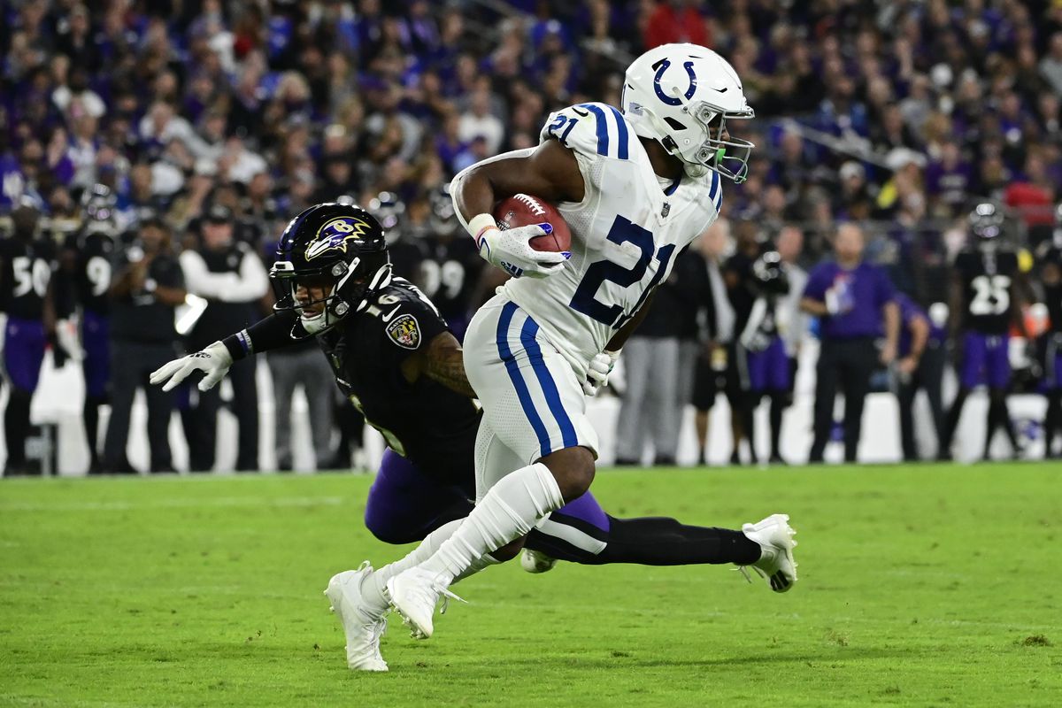 Indianapolis Colts running back Nyheim Hines (21) runs by Baltimore Ravens wide receiver Tylan Wallace (16) on a punt return at M&amp;T Bank Stadium.