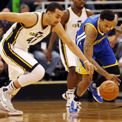Utah Jazz forward Trey Lyles (41) and Golden State Warriors forward Brandon Rush (4) reach for possession of a loose ball in the first half of an NBA regular season game at the Vivint Arena in Salt Lake City, Wednesday, March 30, 2016.