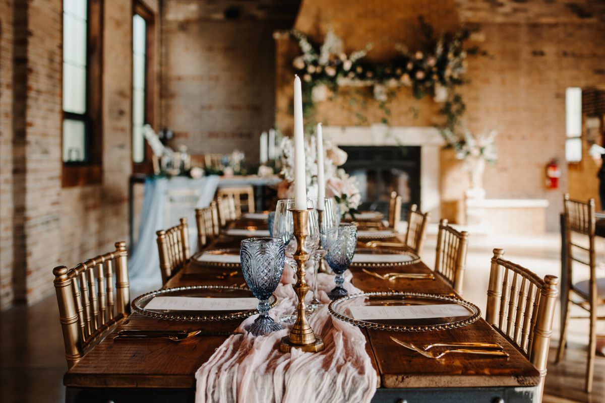 A long wooden table laid for a wedding.