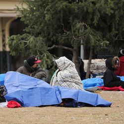 FILE - Homeless people bundle up in downtown Salt Lake City on Thursday, Dec. 8, 2016.