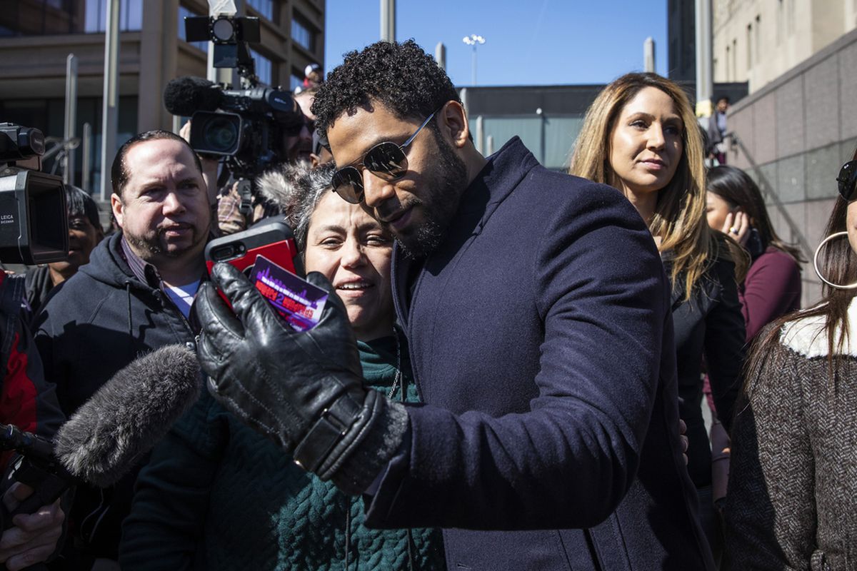 Jussie Smollett takes a selfie with a supporter as he leaves the Leighton Criminal Courthouse.