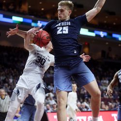 Brigham Young Cougars guard TJ Haws (30) is fouled by San Diego Toreros forward Yauhen Massalski (25) on a layup attempt as the BYU Cougars and San Diego Toreros play in WCC tournament action at the Orleans Arena in Las Vegas on Saturday, March 9, 2019. San Diego won 80-57.