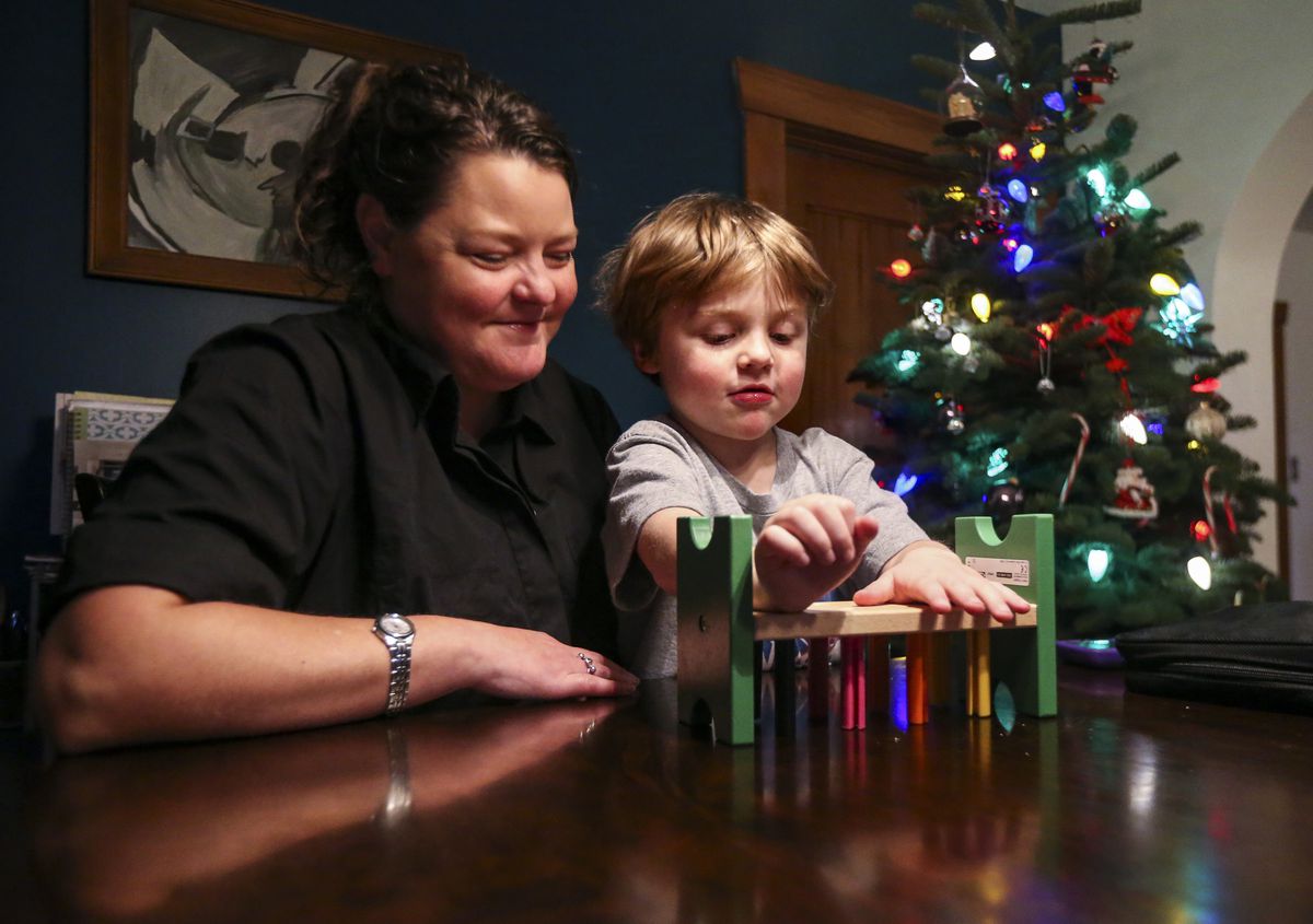 Stephanie Arceneaux plays with her son Darwin Cram, 4, at the dining room table at her home in Salt Lake City on Friday, Dec. 13, 2019. Arceneaux, her son and husband are all Type 1 diabetics.&nbsp;Both Arceneaux and her husband use insulin to regulate their blood sugar, but Darwin doesn’t have to yet.