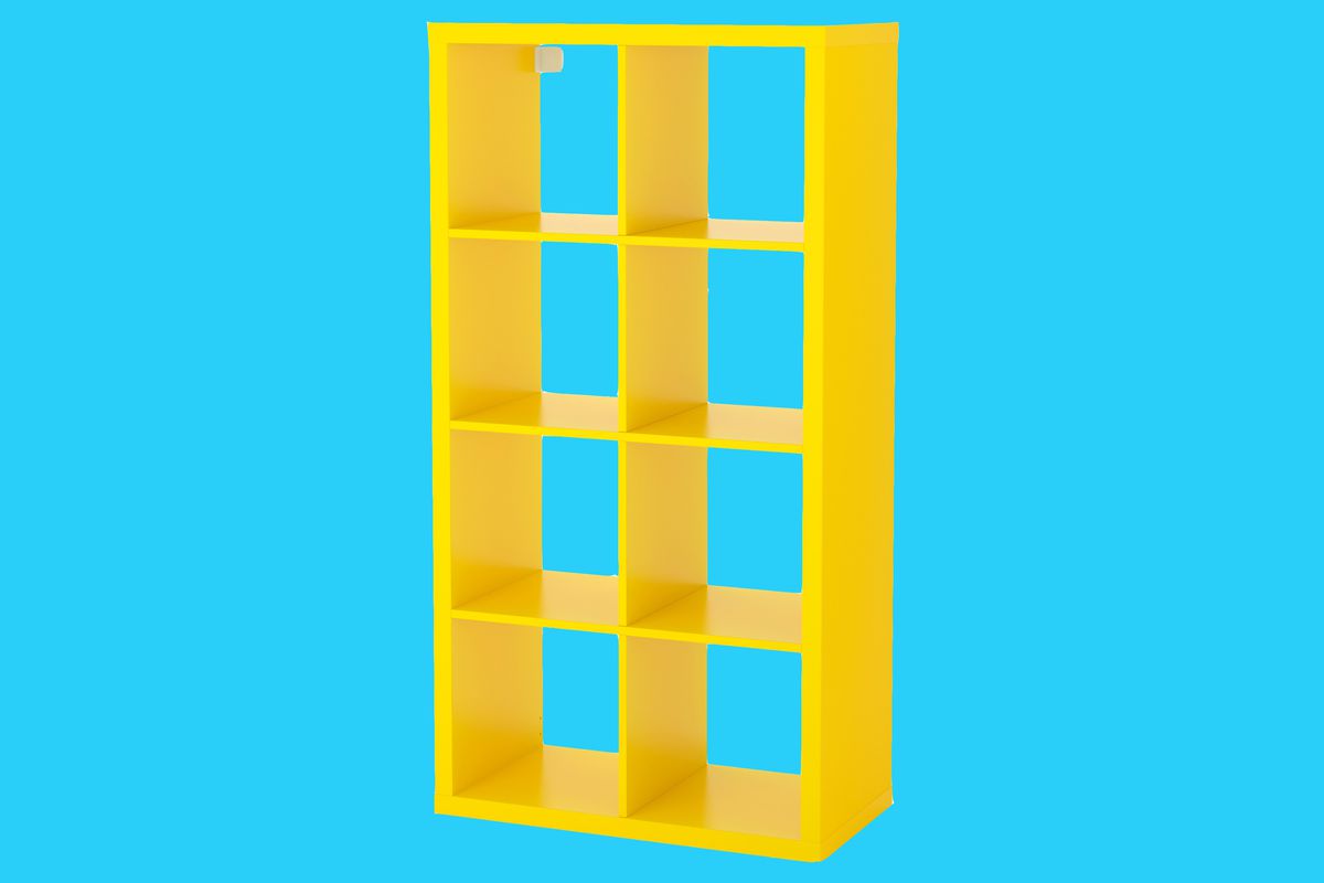 Yellow shelving unit made up of cubbies arranged in a 2x4 grid on a blue background. 
