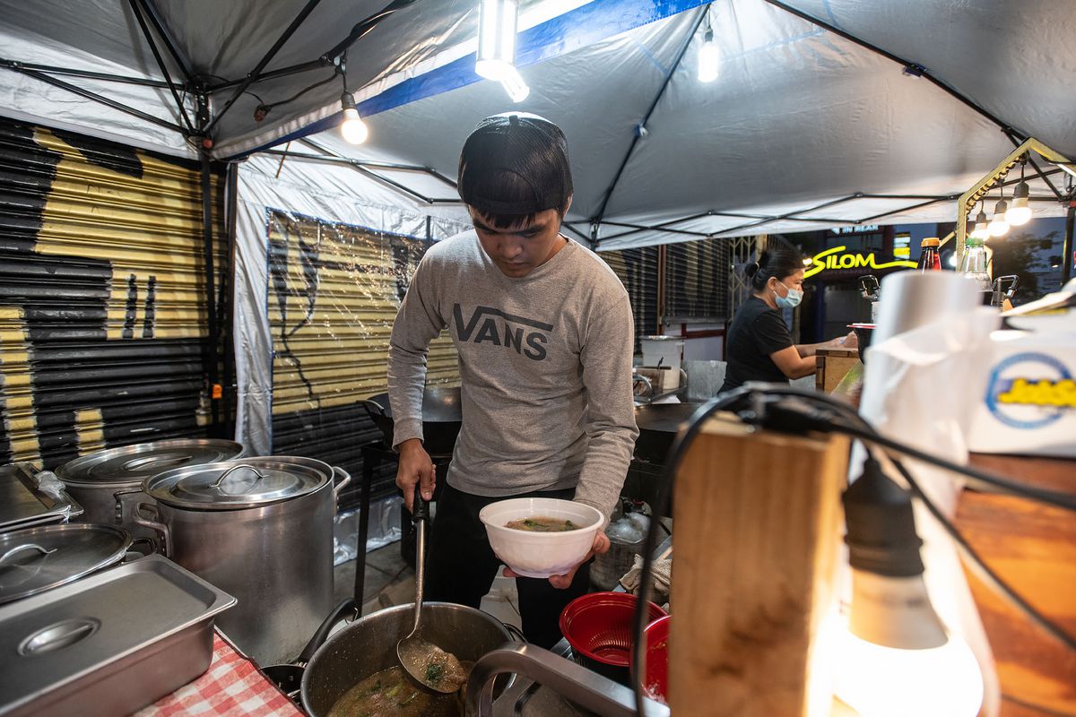 A man stands over a pot preparing Thai noodles at Rad Nah Silom in East Hollywood, California.