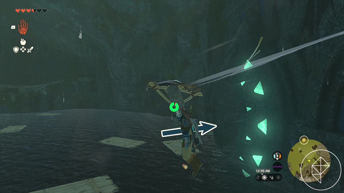 Link uses his paraglider to float above the water, which is now strewn with brown planks. An arrow pointing to the right indicates the player will need to enter a pipe with a glowing green mouth.