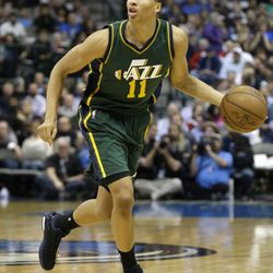 Utah Jazz guard Dante Exum (11) dribles during the first half of an NBA basketball game against the Dallas Mavericks Wednesday, Feb. 11, 2015, in Dallas. (AP Photo/LM Otero)  

