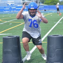 Lake Zurich’s Jackson Farsalas (76) drives straight ahead in the second day of  practice. Worsom Robinson/For the Sun-Times.