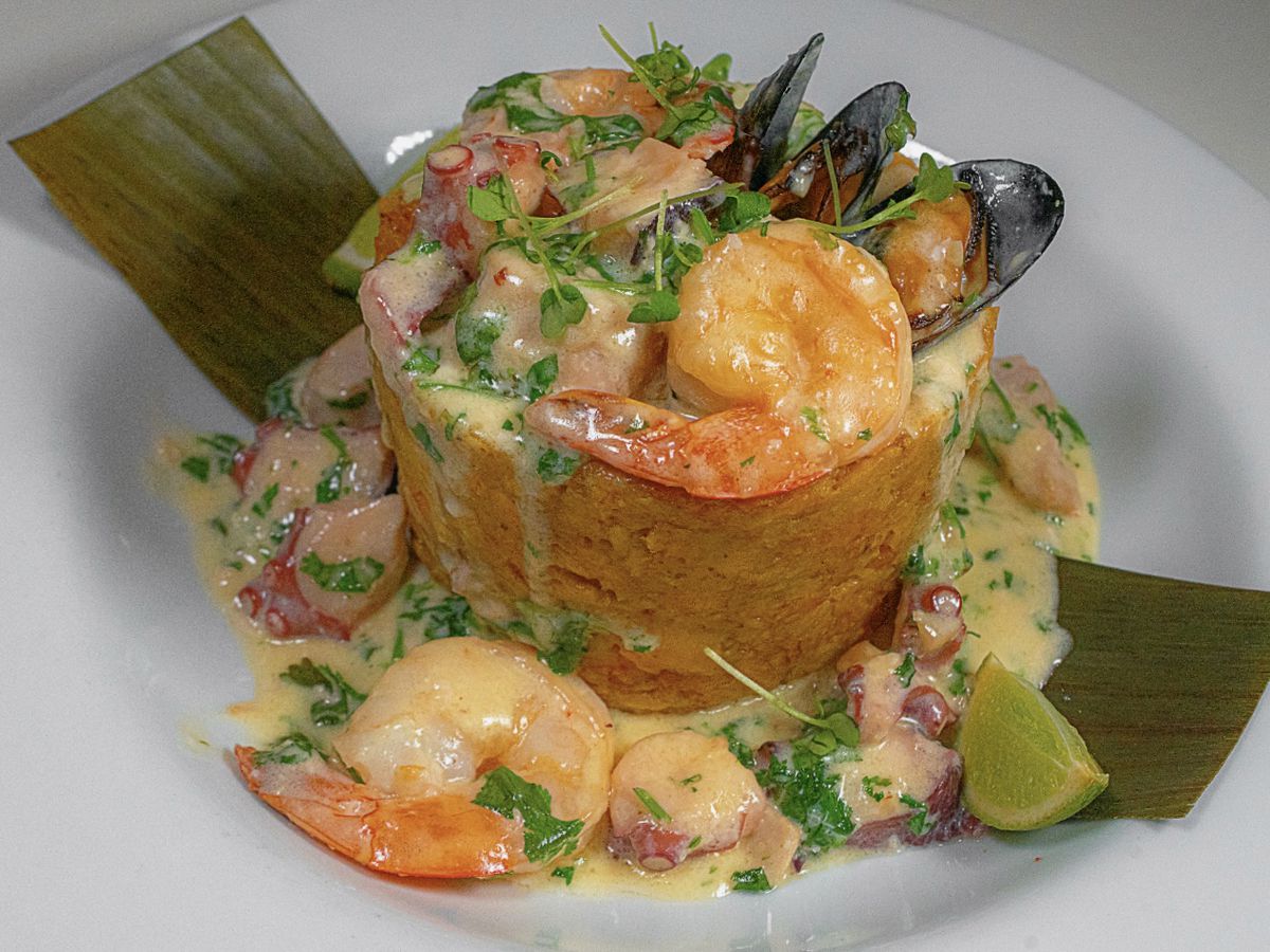 Mofongo topped with shrimp and mussels in a creamy sauce.