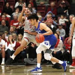 BYU guard Elijah Bryant (3) collides with Stanford guard Dorian Pickens (11) and is called for charging during the first half of an NCAA college basketball game in the first round of the NIT on Wednesday, March 14, 2018, in Stanford, Calif. (AP Photo/Tony Avelar)