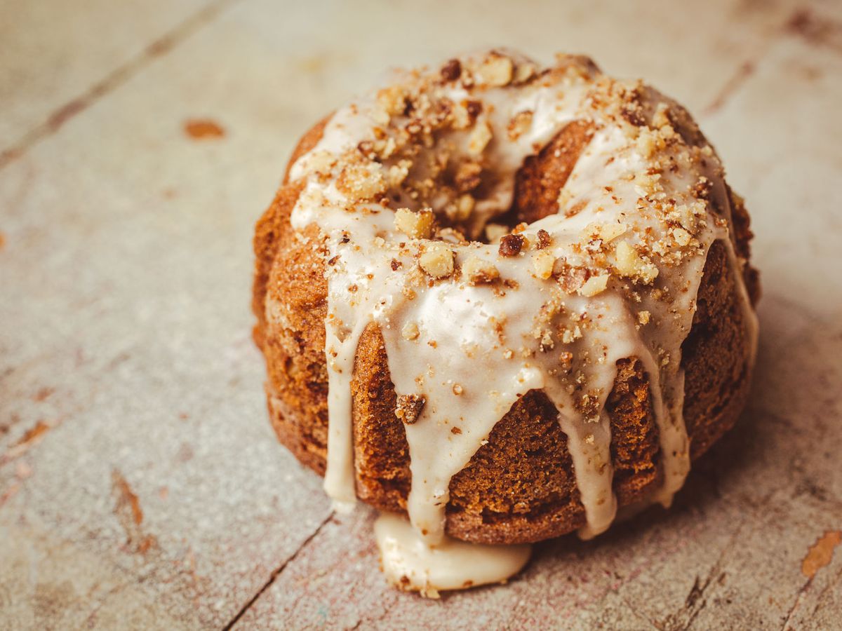 A close-up photo of a mini bundt cake with icing drizzled over top.