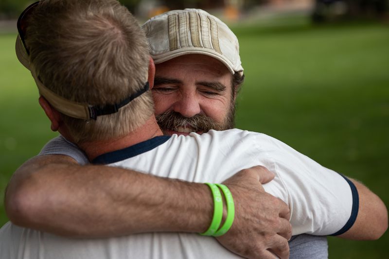 Sean-Paul Schulte hugs friend Scott Gorgacz in Swanny Park in Moab on Sunday, Sept. 19, 2021. Schulte has been in the park every day for the past two weeks seeking community tips in the murder of his daughter, Kylen Schulte, and her wife, Crystal Turner.