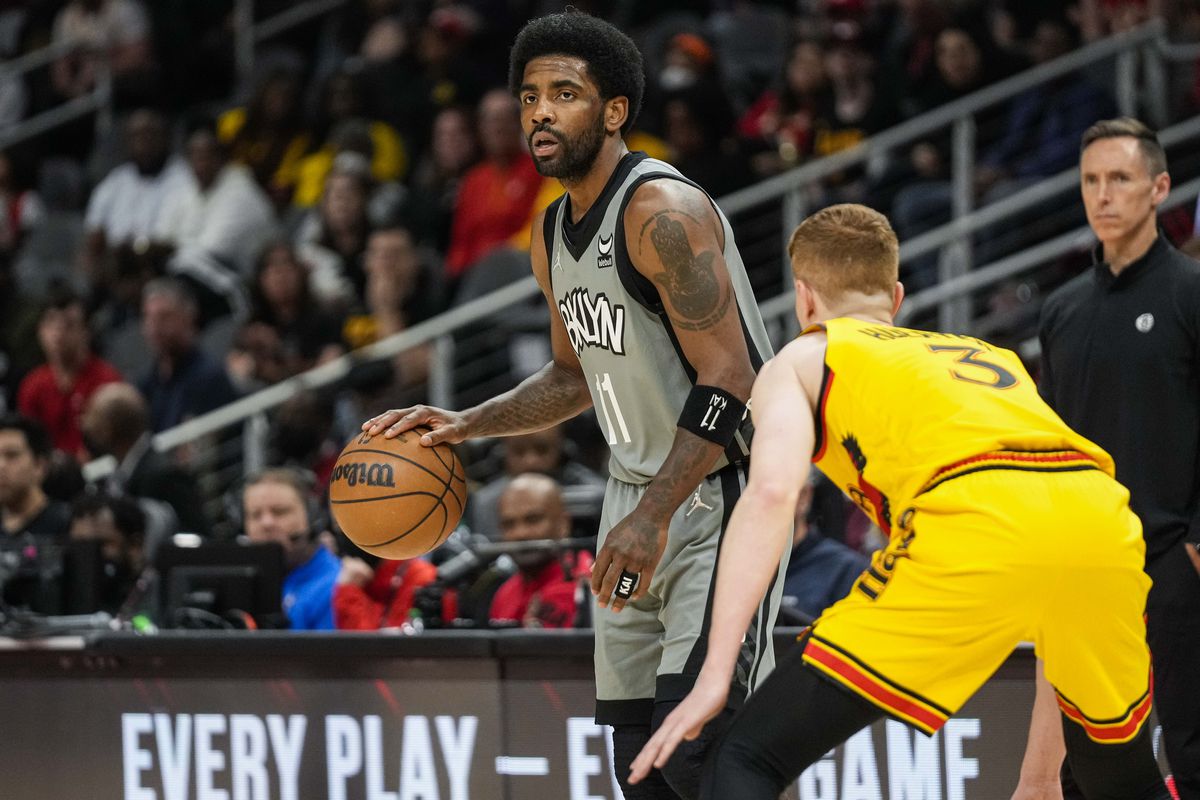 Brooklyn Nets guard Kyrie Irving (11) dribbles guarded by Atlanta Hawks guard Kevin Huerter (3) during the first half at State Farm Arena.