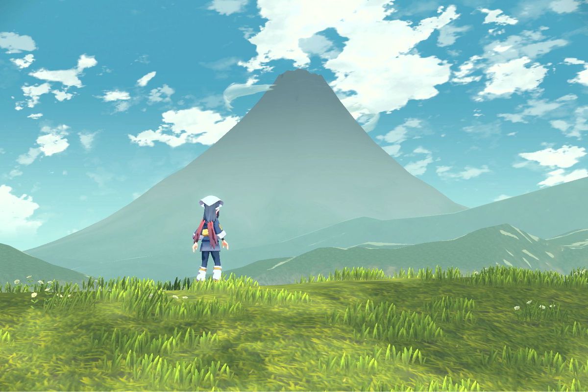 A Pokémon trainer staring off at a distant mountain.