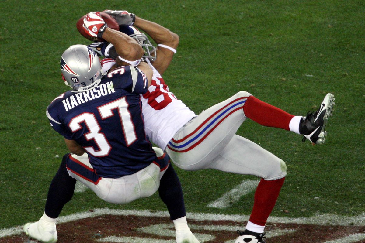 New York Giants’ wide receiver David Tyree pins the ball to