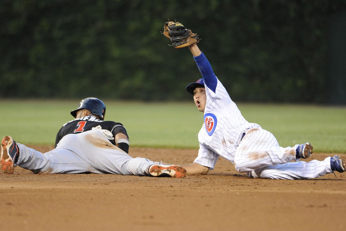Chicago, IL, USA; Chicago Cubs second baseman Darwin Barney tags out Miami Marlins center fielder Emilio Bonifacio at second base on a steal attempt at Wrigley Field. Credit: David Banks-US PRESSWIRE