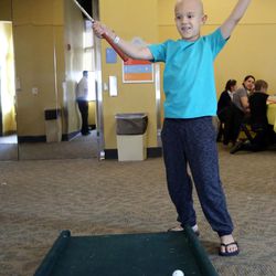 Gabe Galindo makes a putt at Make-A-Wish Utah's annual Easter egg hunt for children facing life-threatening medical conditions at the Discovery Gateway Museum in Salt Lake City on Saturday, March 19, 2016. 