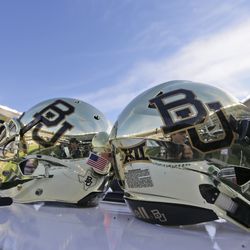 FILE - In this Dec. 5, 2015, file photo, Baylor helmets on shown the field after an NCAA college football game in Waco, Texas. The NCAA board of governors has adopted a policy that requires sexual violence education for all college athletes, coaches and athletics administrators. Campus leaders such as athletic directors and school presidents will be required to attest that athletes, coaches and administrators have been educated on sexual violence each year. The move follows a number of high-profile assault cases, including Baylor.