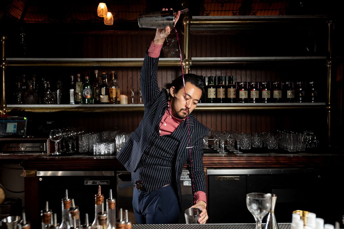 Kevin Lee bartender pouring a drink with flair at The Wolves in Downtown LA