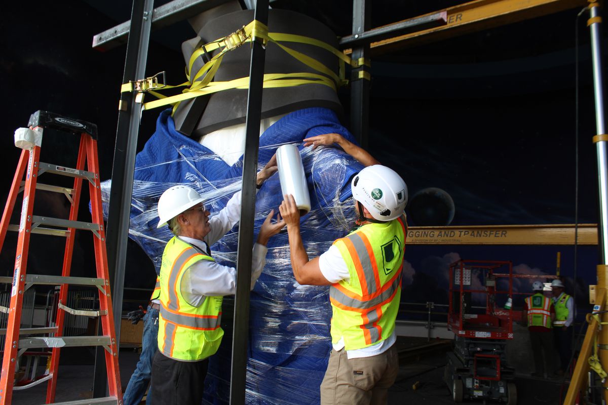 Workers secure the 11-foot Christus statue before demolition begins on Temple Square’s North Visitors’ Center.