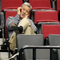 FILE - The University of Utah Athletics Director Dr. Chris Hill talks on his phone while watching the Utes Wednesday, March 18, 2015, as they prepare to play Stephen F. Austin in the second round of the NCAA tournament in Portland Oregon at the Moda Center.