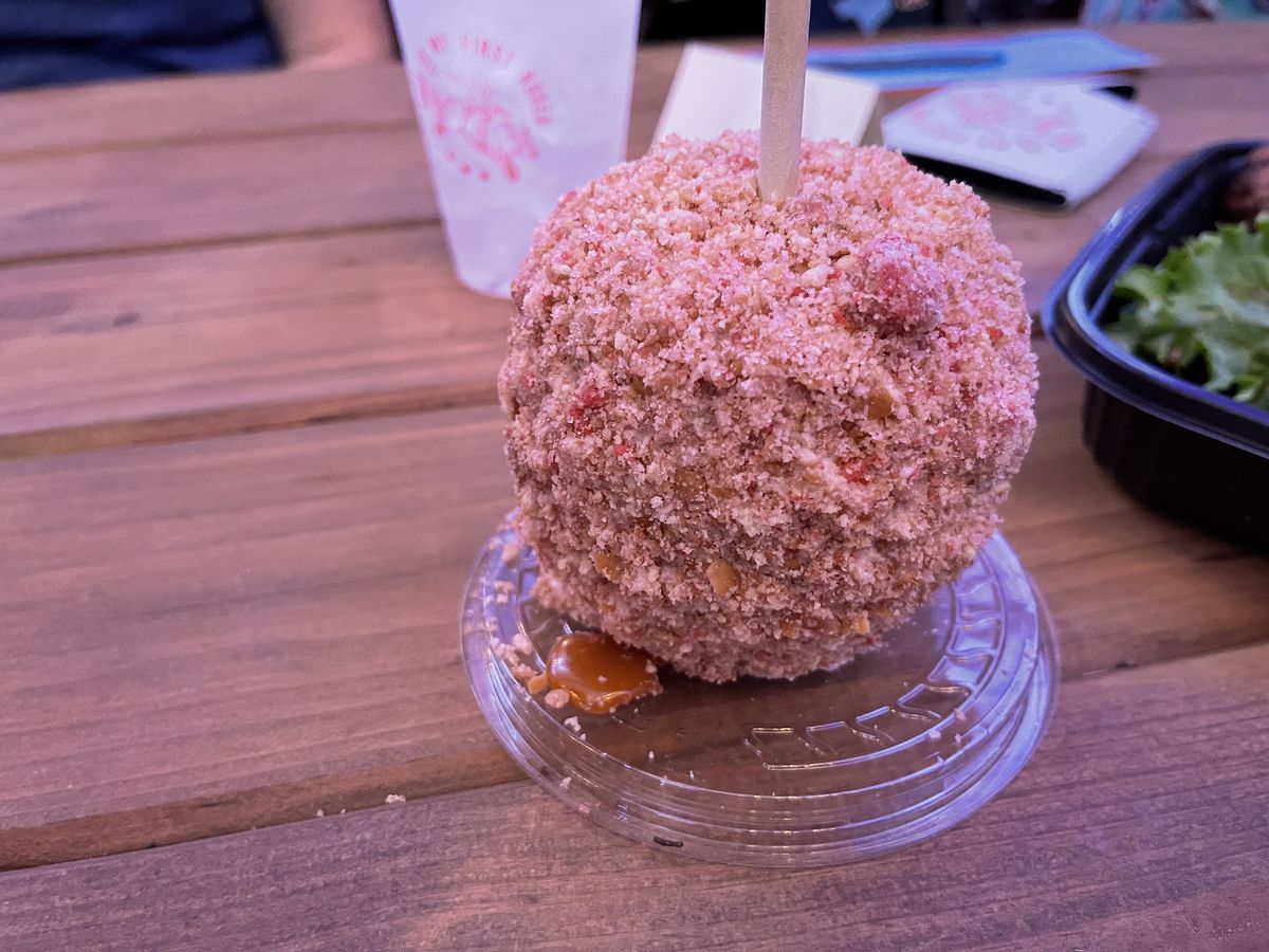 a pink candy-coated apple on a stick.