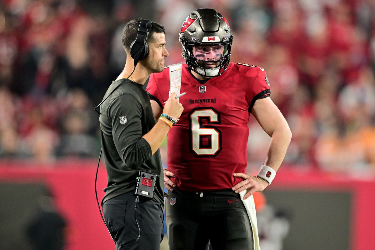 Offensive Coordinator Dave Canales of the Tampa Bay Buccaneers talks with Baker Mayfield #6 against the Philadelphia Eagles during the fourth quarter in the NFC Wild Card Playoffs at Raymond James Stadium on January 15, 2024 in Tampa, Florida.
