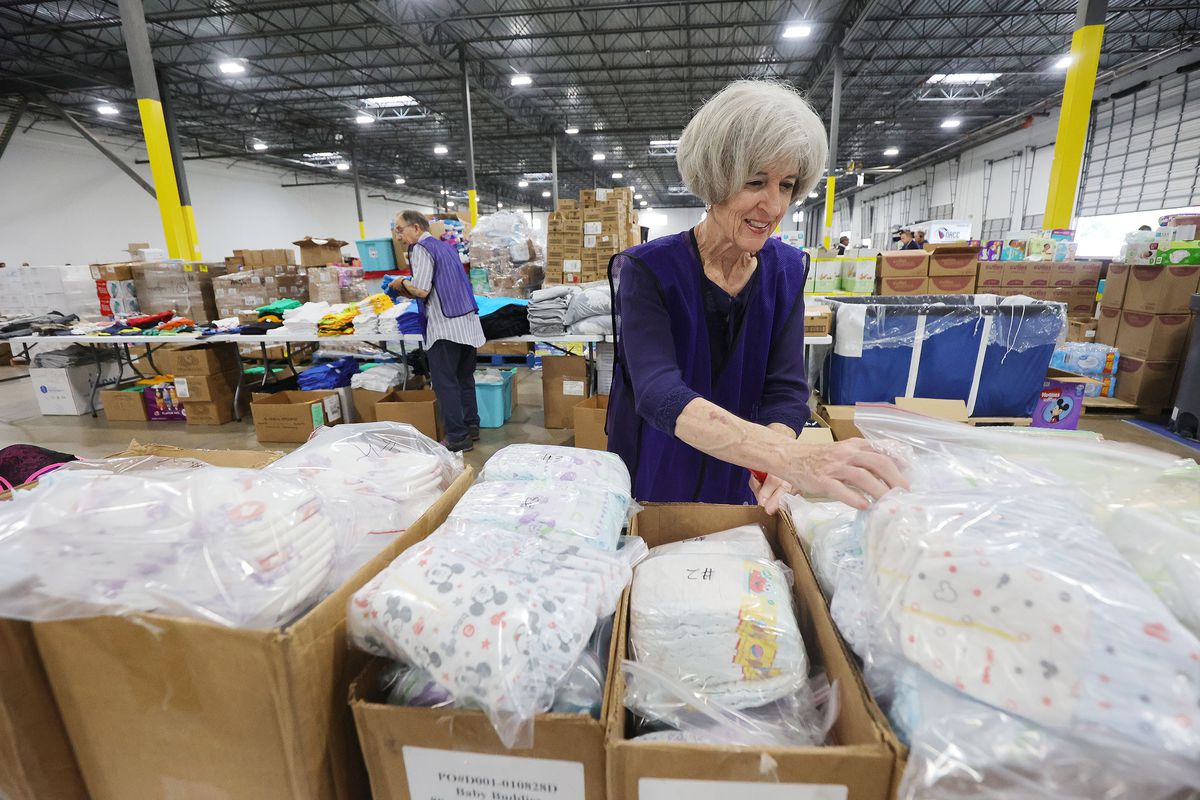 Elder Brent Lee, left, and and Sister Charlene Lee, Latter-day Saint service missionaries, sort donated items for refugees at the Family Transfer Center in Houston on Monday, June 7, 2021. The center provides a temporary respite for families who have been cleared at the U.S. border and need short-term shelter and food. The creation of the Family Transfer Center is the result of a collaboration between The Church of Jesus Christ of Latter-day Saints, Catholic Charities, the National Association of Christian Churches, YMCA International Services, Texas Adventist Community Services, Houston Responds and The Houston Food Bank.