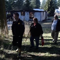 The owners of the home where Josh Powell lived walk away after looking at it in Graham, Wash., Monday, Feb. 6, 2012.