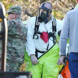 Police and agents with the Drug Enforcement Administration put on protective gear as local and federal law enforcement agencies respond to a drug lbust in Cottonwood Heights on Tuesday, Nov. 22, 2016. DEA agents discovered at least several hundred thousand illicit fentanyl pills at a home in what they called an "absolutely catastrophic" undercover drug dealing operation.