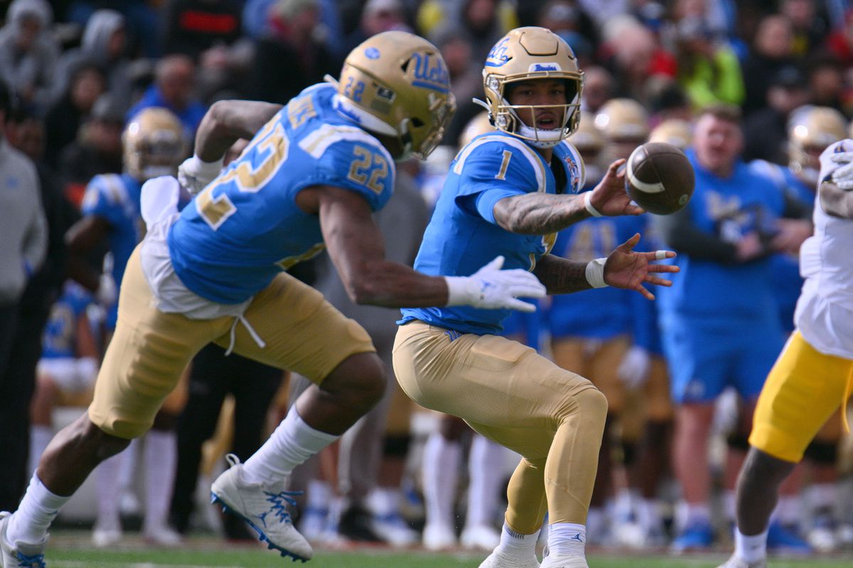 Quarterback Dorian Thompson-Robinson #1 of the UCLA Bruins pitches the ball to running back Keegan Jones #22 during the second half of the Tony the Tiger Sun Bowl game between the Pittsburgh Panthers and the Bruins at Sun Bowl Stadium on December 30, 2022 in El Paso, Texas. The Panthers defeated the Bruins 37-35.