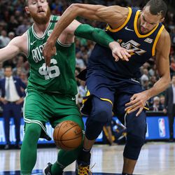 Boston Celtics center Aron Baynes (46) and Utah Jazz center Rudy Gobert (27) scramble for a loose ball during the game at Vivint Smart Home Arena in Salt Lake City on Wednesday, March 28, 2018.
