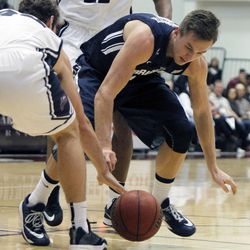 BYU guard Kyle Collinsworth, right, battles Loyola Marymount guard David Humphries for the ball during the first half of an NCAA college basketball game in Los Angeles, Saturday, Feb. 7, 2015.