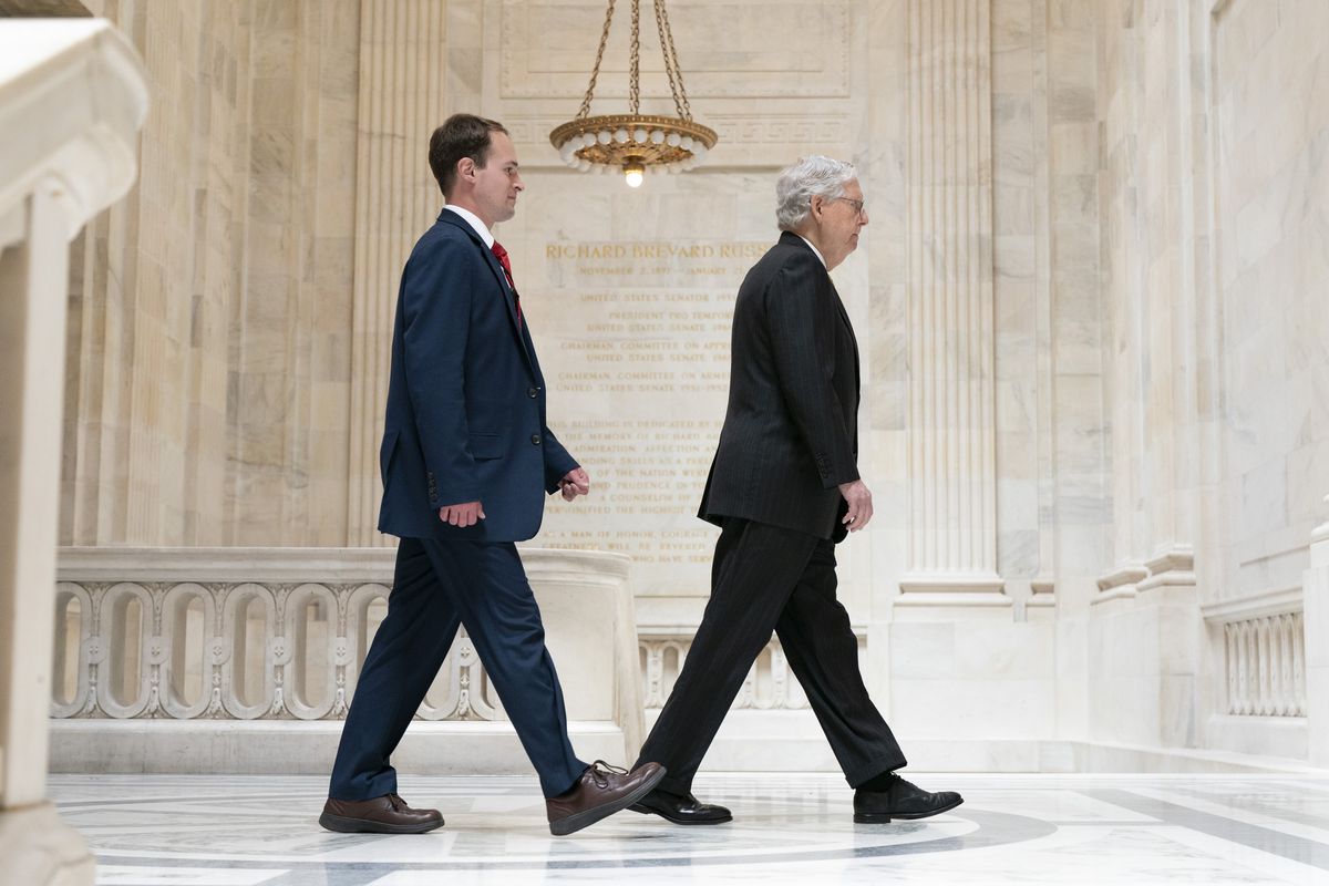 Senate Minority Leader Mitch McConnell of Ky., right, walks with a staffer, Tuesday, May 18, 2021, to a meeting with Senate Republicans on Capitol Hill in Washington. 