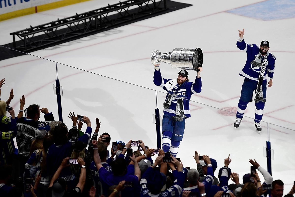 Jul 7, 2021; Tampa, Florida, USA; Tampa Bay Lightning center Brayden Point (21) hoists the Stanley Cup after the Lightning defeated the Montreal Canadiens 1-0 in Game 5 to win the 2021 Stanley Cup Final at Amalie Arena.