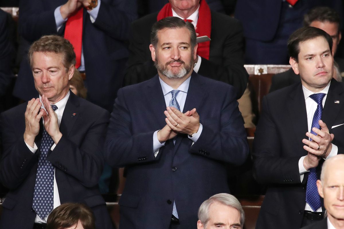 Republican Sen. Ted Cruz (center) with colleagues Rand Pau (left) and Marco Rubio applaud as Donald Trump delivers his State Of The Union address in February.
