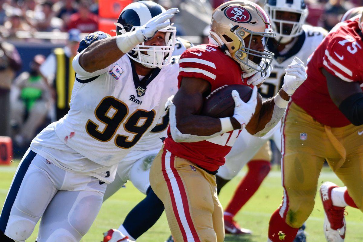 Los Angeles Rams defensive tackle Aaron Donald tackles San Francisco 49ers running back Matt Breida during the first half at Los Angeles Memorial Coliseum.