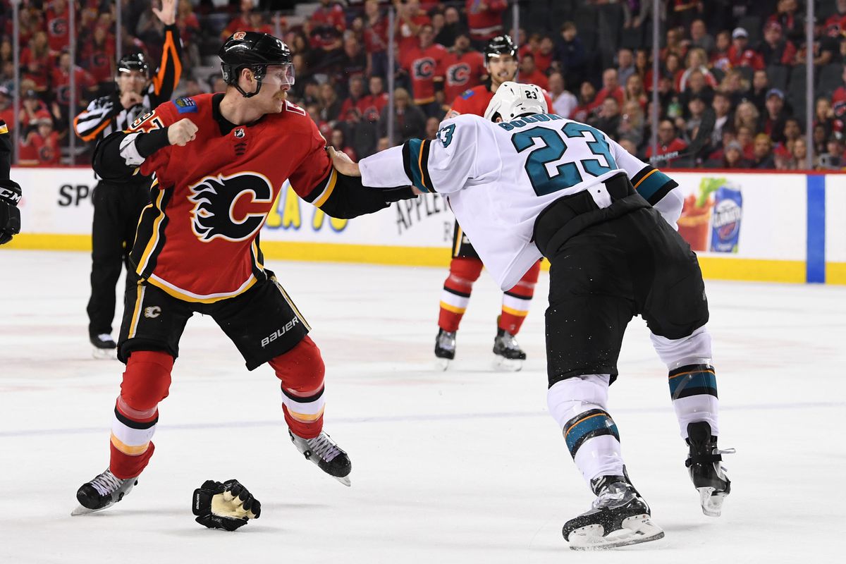 Dec 31, 2018; Calgary, Alberta, CAN; Calgary Flames center Sam Bennett (93) squares off against San Jose Sharks left wing Barclay Goodrow (23) during the third period at Scotiabank Saddledome. The Flames won 8-5.