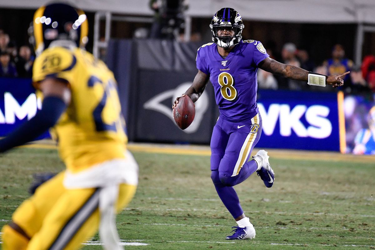 Baltimore Ravens quarterback Lamar Jackson carries the ball during the third quarter against the Los Angeles Rams at Los Angeles Memorial Coliseum.