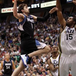 Alexey Shved of the Minnesota Timberwolves goes up for a shot against Derrick Favors of the Utah Jazz during NBA basketball in Salt Lake City Friday, April 12, 2013.