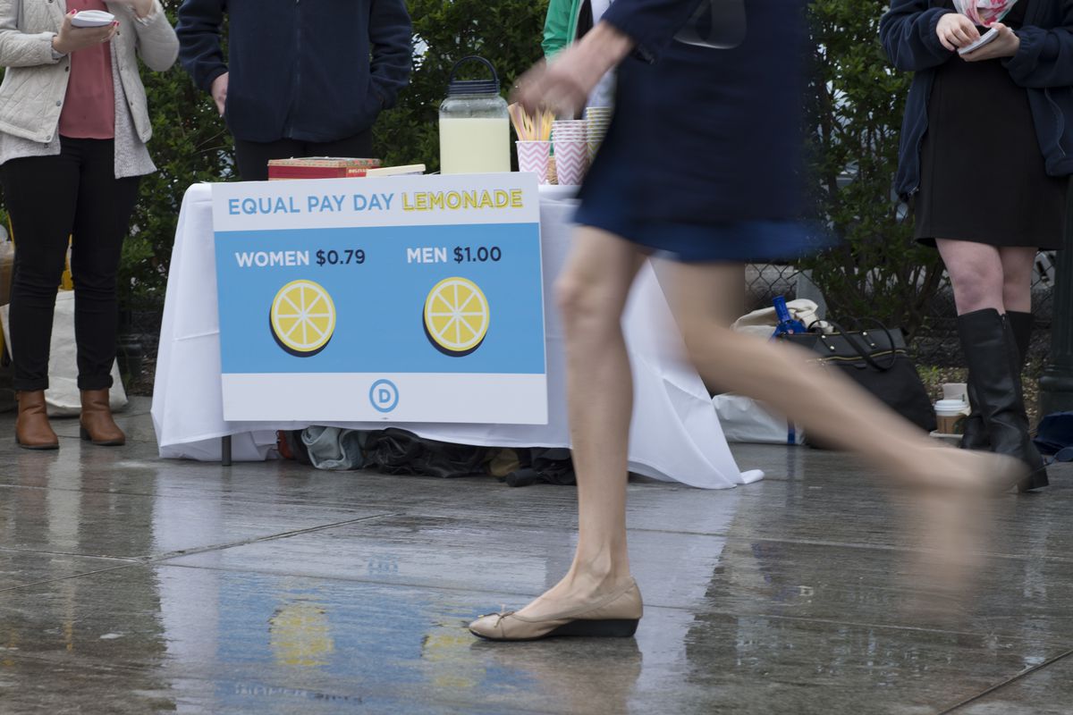 Women from the Democratic National Committee host an Equal Pay Day event with a lemonade stand to highlight the gender pay gap on April 12, 2016 in Washington, DC