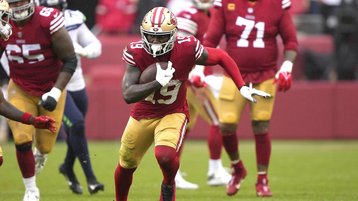 Deebo Samuel #19 of the San Francisco 49ers runs with the ball after making a catch against the Seattle Seahawks during the second half at Levi’s Stadium on September 18, 2022 in Santa Clara, California.