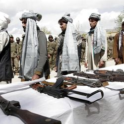 Former Taliban line up after turning in their weapons during a ceremony with the Afghan government in Mehterlam, Laghman province, east of Kabul, Afghanistan, Wednesday, April 3, 2013. About seven former Taliban militants from Laghman province handed over their weapons as part of a peace-reconciliation program. (AP Photo/Rahmat Gul)